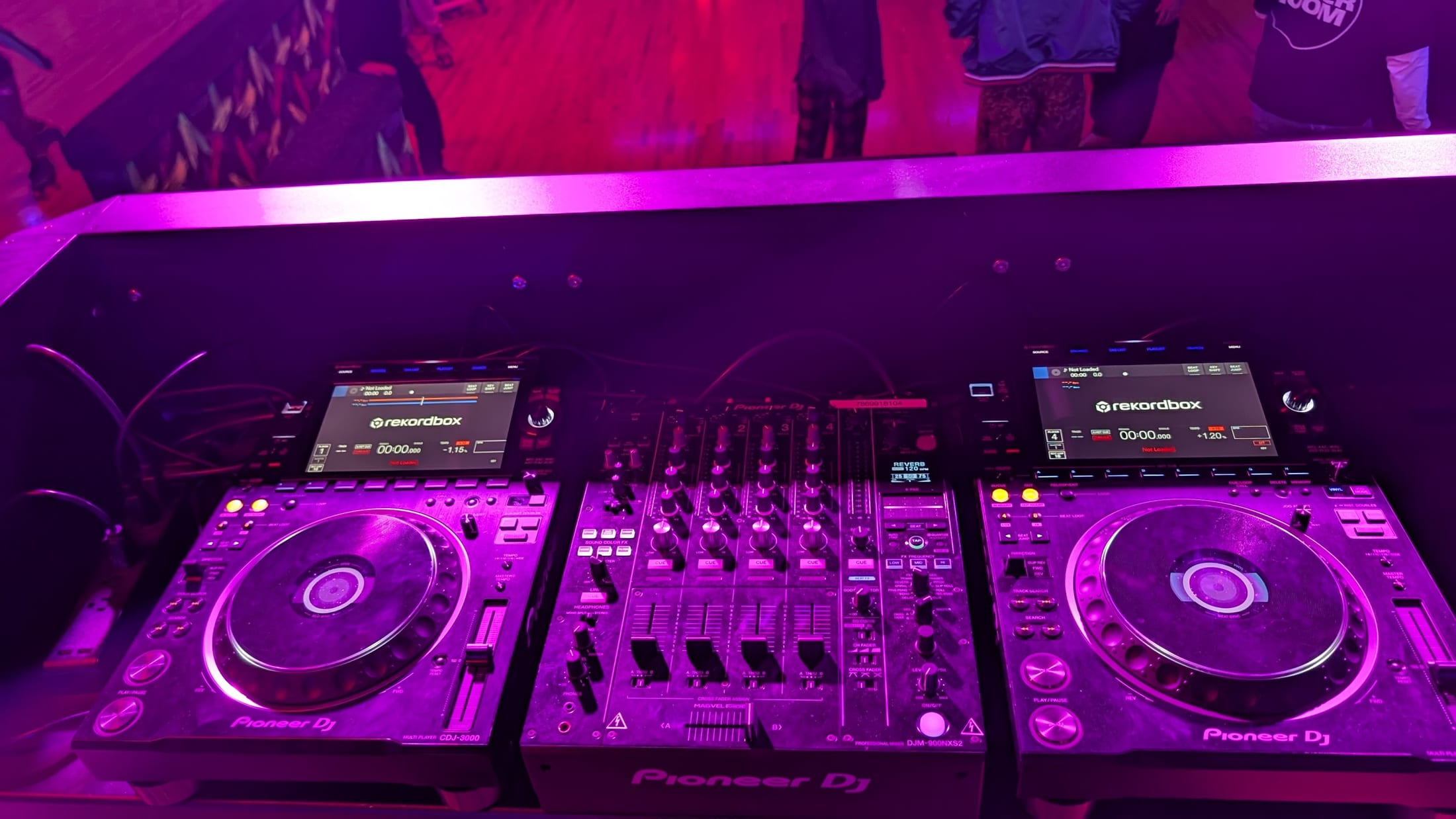 Pioneer CDJ-3000 players and DJM-900NXS2 under event lighting
