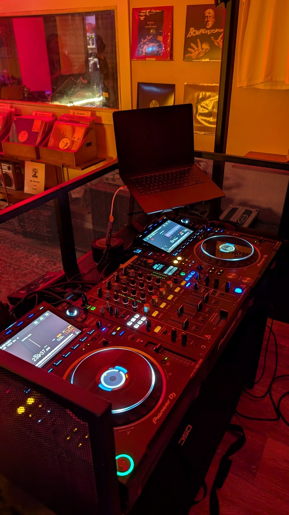 Pioneer CDJ-3000 players and a DJM-900NXS2 mixer in a professional DJ booth