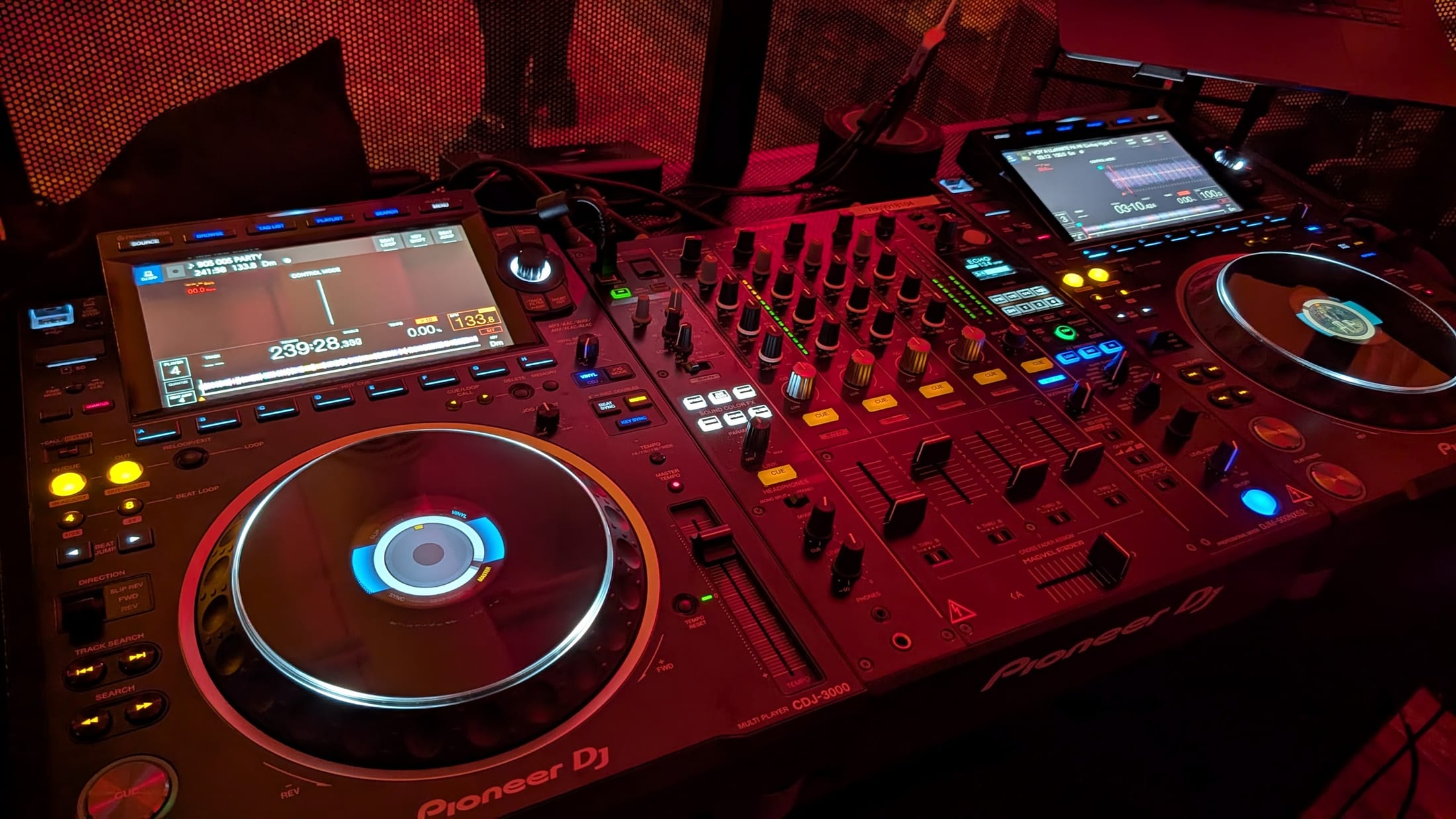 Complete Pioneer DJ setup with a laptop and professional booth