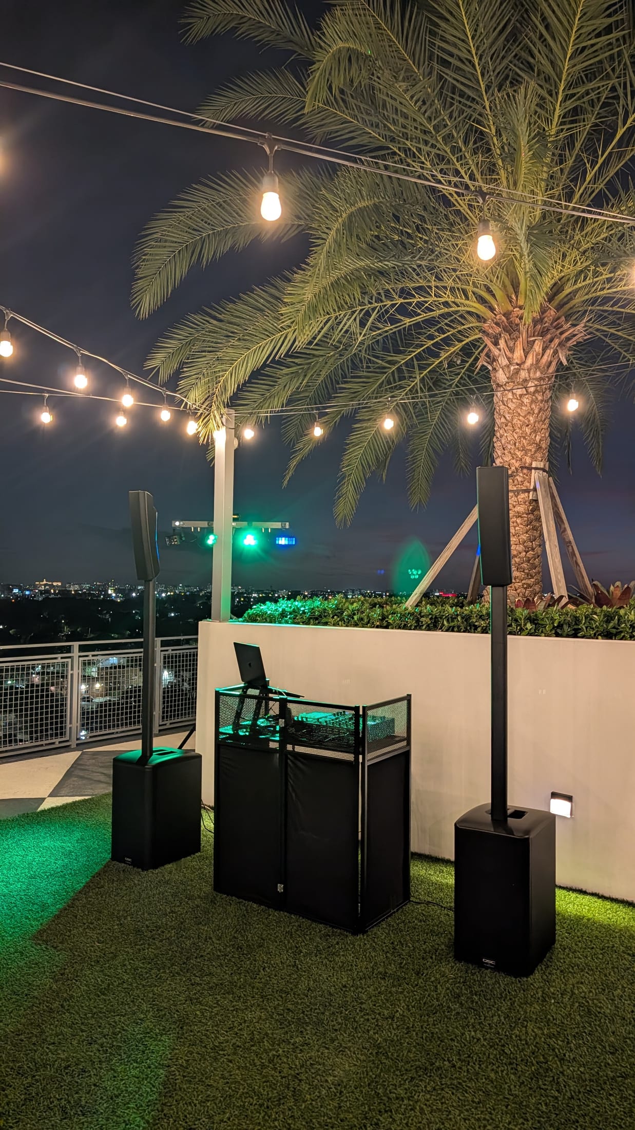 QSC column speakers arranged for a nighttime Miami rooftop event