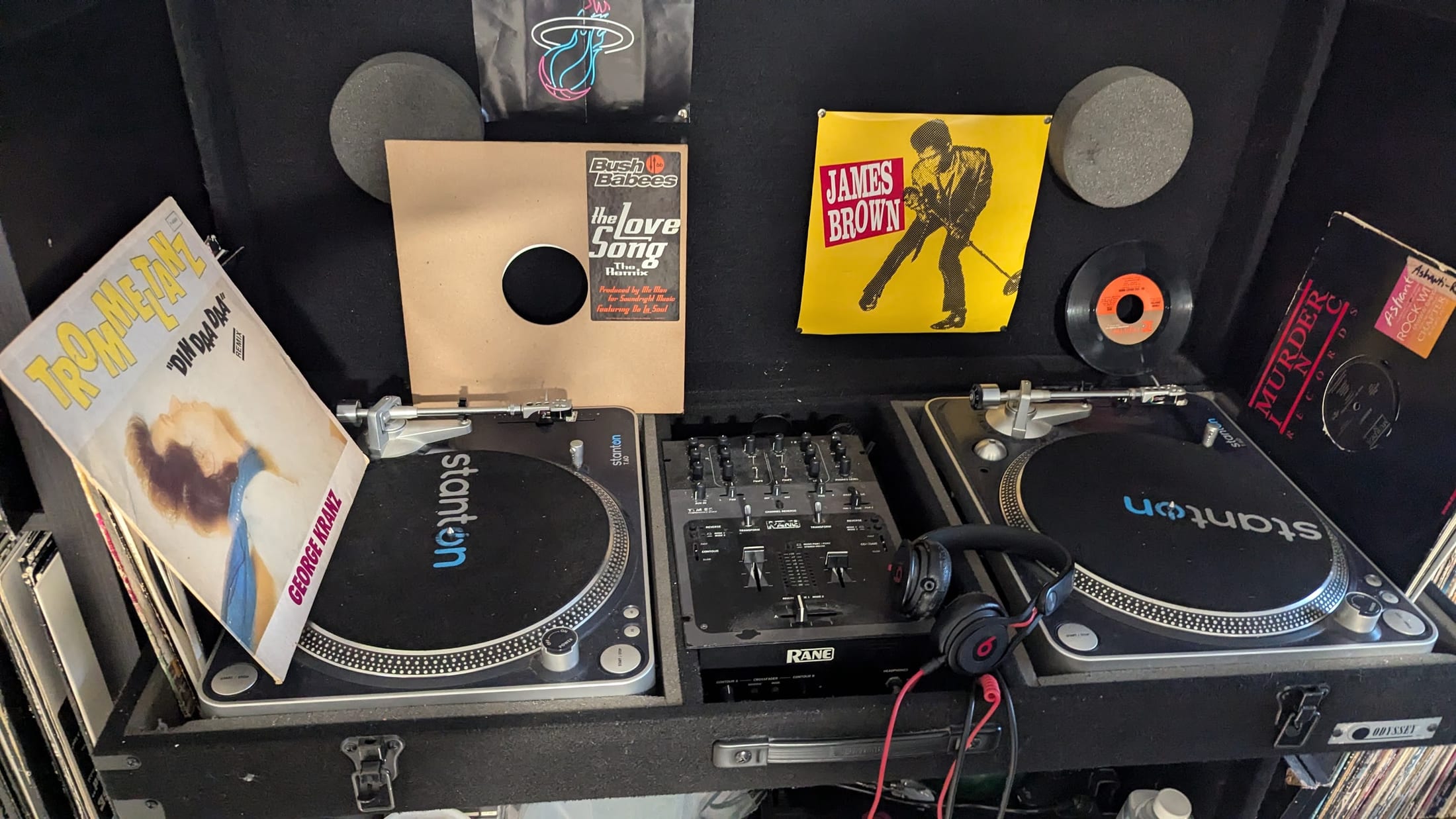 Turntables, vinyl records and a professional DJ mixer